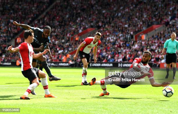 Raheem Sterling of Manchester City shoots but is blocked by Ryan Bertrand of Southampton during the Premier League match between Southampton and...