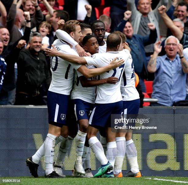 Erik Lamela of Tottenham Hotspur celebrates with teammates after scoring his sides fourth goal during the Premier League match between Tottenham...