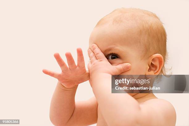 baby hiding with hands xl - hidw and seek stock pictures, royalty-free photos & images