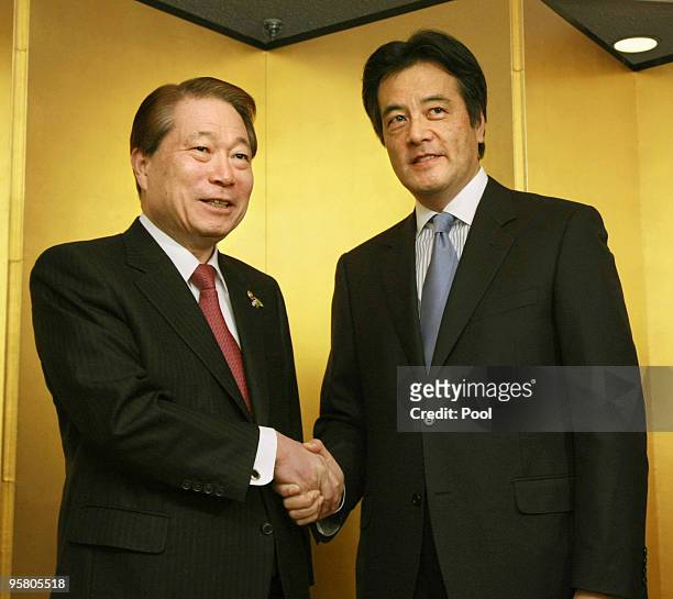 Japan's Foreign Minister Katsuya Okada shakes hands with his South Korean counterpart Yu Myung-hwan during a two-day meeting by East Asian and Latin...