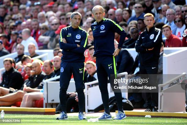Chris Hughton, Manager of Brighton and Hove Albion and Paul Trollope, Assistant manager looks on during the Premier League match between Liverpool...