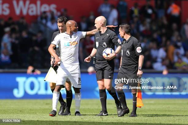 Andre Ayew of Swansea City in discussion with match referee Anthony Taylor during the Premier League match between Swansea City and Stoke City at...