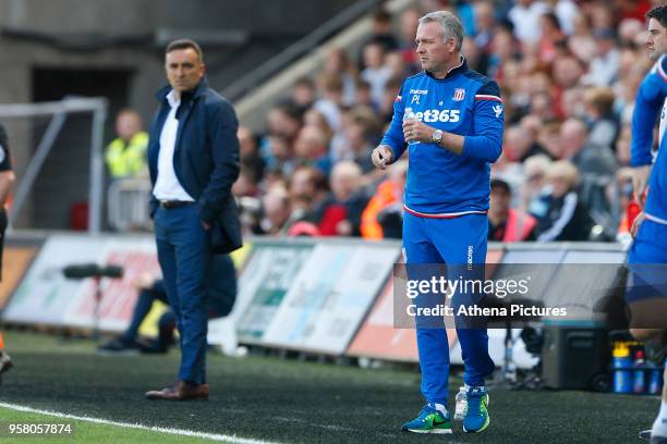 Swansea City manager Carlos Carvalhal watches Stoke City manager Paul Lambert during the Premier League match between Swansea City and Stoke City at...