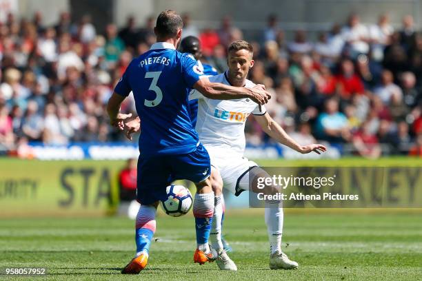 Andy King of Swansea City challenges Erik Pieters of Stoke City during the Premier League match between Swansea City and Stoke City at Liberty...