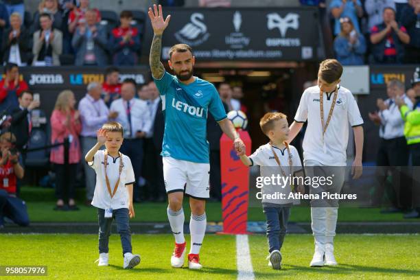 Leon Britton of Swansea City walks onto the pitch to thank home supporters prior to the game during the Premier League match between Swansea City and...