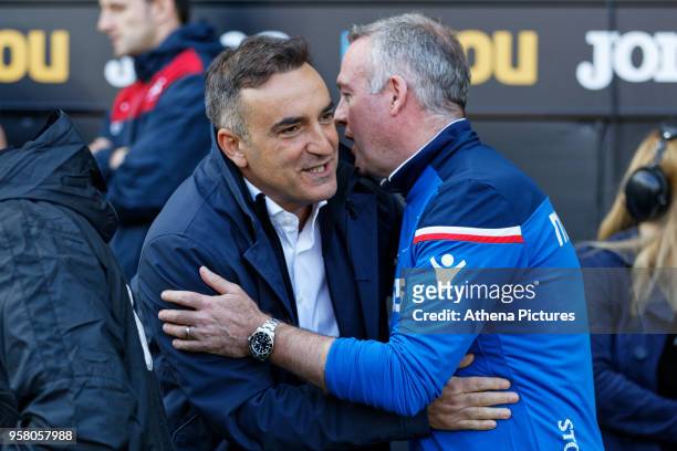 Swansea manager Carlos Carvalhal greets Stoke City manager Paul Lambert prior to the game during the Premier League match between Swansea City and...