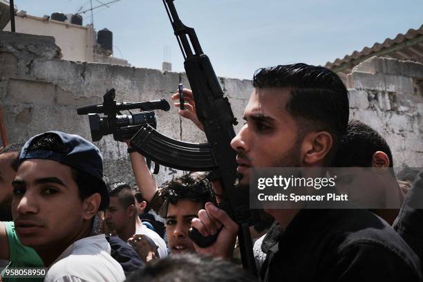 People march with the body of Jamal Affana as he brought through a Rafa, Gaza alleyway after he succumbed to a gunshot wound sustained during...