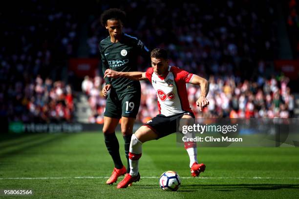 Dusan Tadic of Southampton controls the ball as Leroy Sane of Manchester City looks on during the Premier League match between Southampton and...