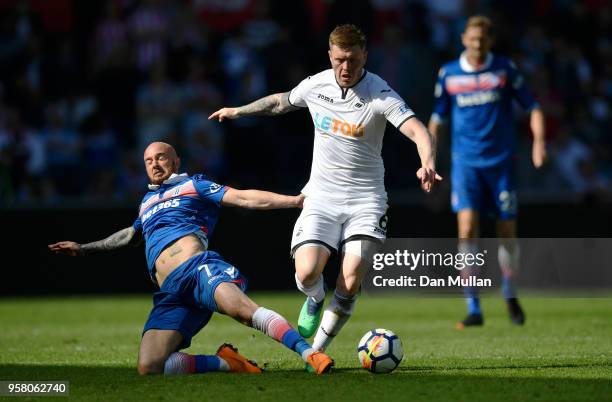 Stephen Ireland of Stoke City tackles Alfie Mawson of Swansea City during the Premier League match between Swansea City and Stoke City at Liberty...