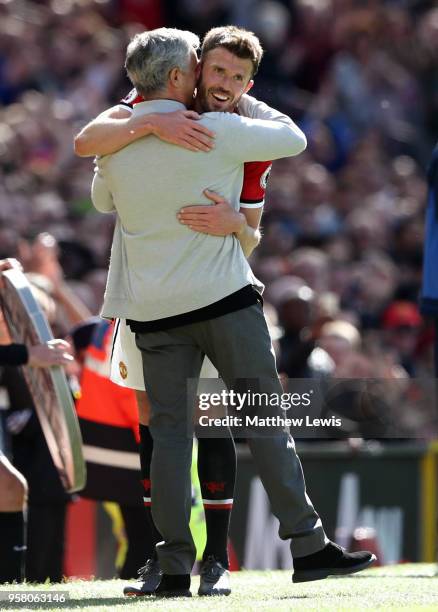 Michael Carrick of Manchester United is embraced by Jose Mourinho, Manager of Manchester United after he is subsituted during the Premier League...