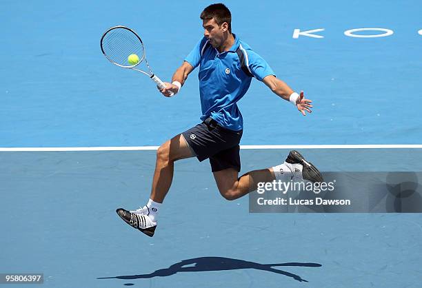Novak Djokovic of Serbia plays a forehand in his exhibition match against Bernard Tomic of Australia during day four of the 2010 Kooyong Classic at...