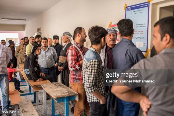 Voters head to polling stations to cast their vote for the Iraqi parliamentary election on May 12, 2018 in Erbil, Iraq. Citizens are voting in the...