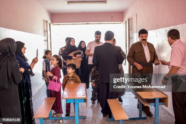 Voters head to polling stations to cast their vote for the Iraqi parliamentary election on May 12, 2018 in Erbil, Iraq. Citizens are voting in the...