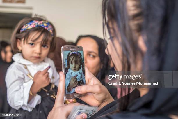 Voters head to polling stations to cast their vote for the Iraqi parliamentary election on May 12, 2018 in Erbil, Iraq. Citizens are voting in the...