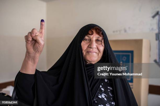 Voters head to polling stations to cast their vote for the Iraqi parliamentary election on May 12, 2018 in Erbil, Iraq. Citizens are voting in the...