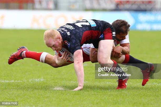 Maurice Blair of Hull KR tackles Liam Farrell of Wigan Warriors during round six of the Ladbrokes Challenge Cup at KCOM Craven Park on May 13, 2018...