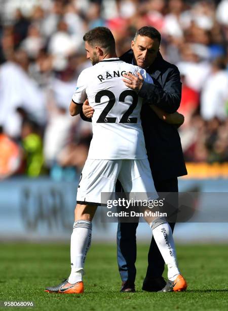 Angel Rangel of Swansea City is embraced by Carlos Carvalhal, Manager of Swansea City after the Premier League match between Swansea City and Stoke...