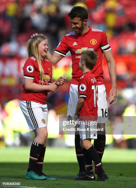 Michael Carrick of Manchester United shows appreciation to the fans during the lap of honour with his family after the Premier League match between...