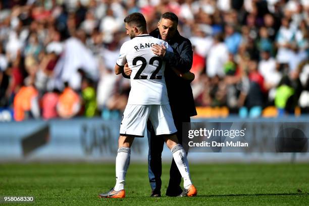 Angel Rangel of Swansea City and Carlos Carvalhal, Manager of Swansea City hug after the Premier League match between Swansea City and Stoke City at...