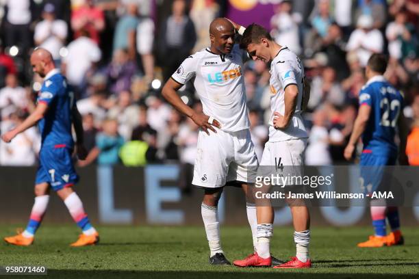 Andre Ayew of Swansea City and Tom Carroll of Swansea City dejected at full time after relegation is confirmed from the Premier league during the...
