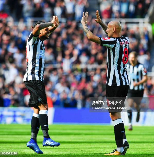 Jonjo Shelvey of Newcastle United celebrates with DeAndre Yedlin after he scores Newcastle's second goal during the Premier League Match between...