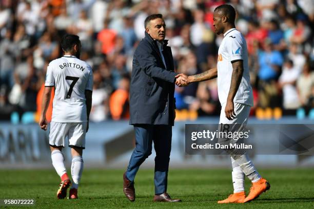 Jordan Ayew and Carlos Carvalhal, Manager of Swansea City shake hands during the Premier League match between Swansea City and Stoke City at Liberty...