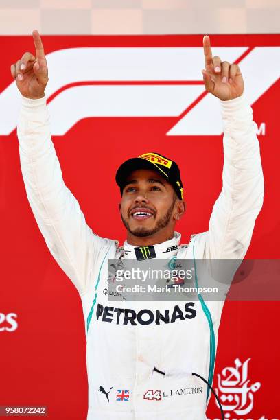 Race winner Lewis Hamilton of Great Britain and Mercedes GP celebrates on the podium during the Spanish Formula One Grand Prix at Circuit de...