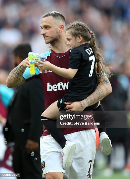 Marko Arnautovic of West Ham United enjoys the lap of honour with his child after the Premier League match between West Ham United and Everton at...