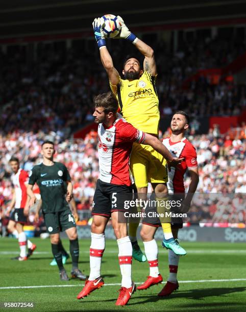 Claudio Bravo of Manchester City collects the ball under pressure from Jack Stephens of Southampton during the Premier League match between...