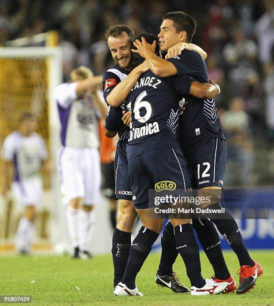 Grant Brebner and Rodrigo Vargas congratulate Carlos Hernandez on the pass that set up the Victory's second goal during the round 23 A-League match...