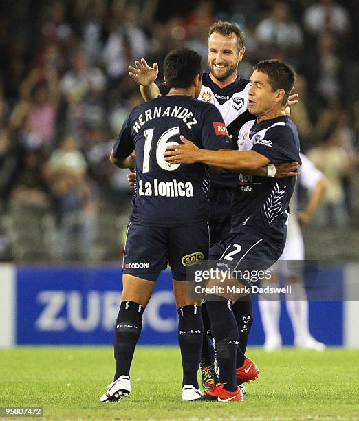 Grant Brebner and Rodrigo Vargas congratulate Carlos Hernandez on the pass that set up the Victory's second goal during the round 23 A-League match...