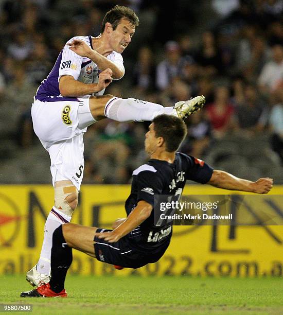 Jamie Harnwell of the Glory shoots at goal over Rodrigo Vargas of the Victory during the round 23 A-League match between the Melbourne Victory and...