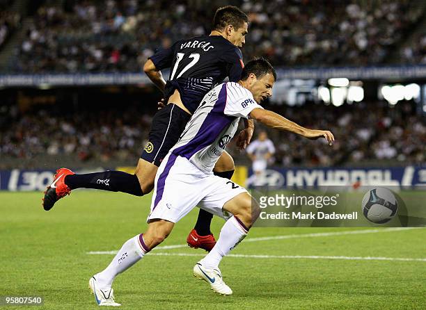 Mile Sterjovski of the Glory leads Rodrigo Vargas of the Victory for the ball during the round 23 A-League match between the Melbourne Victory and...