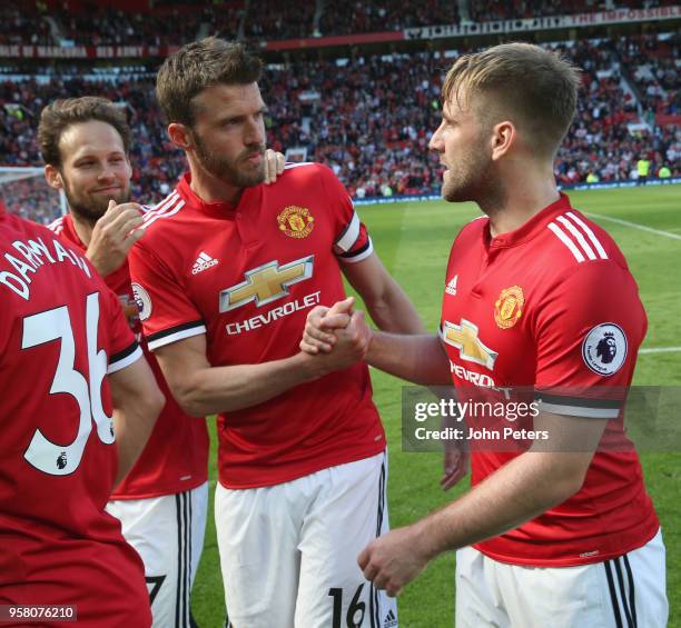 Michael Carrick of Manchester United talks to Luke Shaw after the Premier League match between Manchester United and Watford at Old Trafford on May...