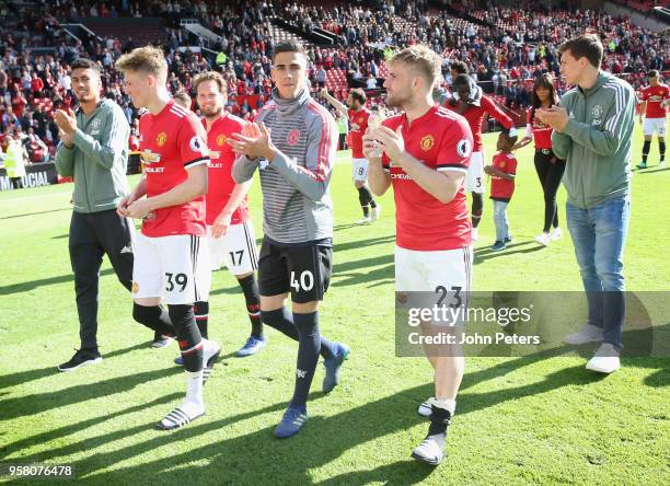 Scott McTominay, Joel Pereira and Luke Shaw of Manchester United take part in a lap of honour after the Premier League match between Manchester...