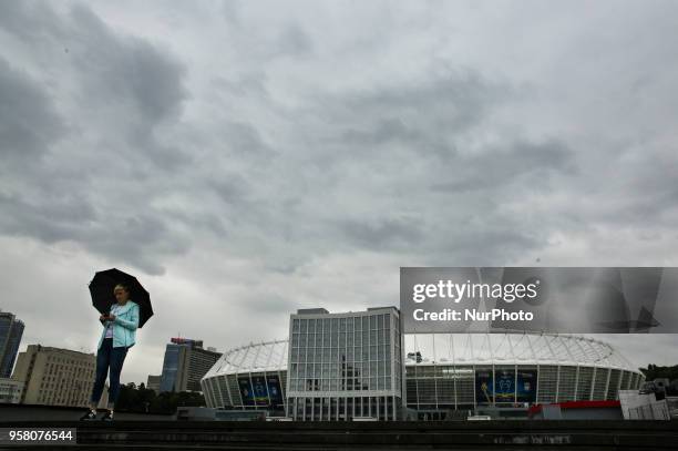 Woman walks near NSC Olimpiyskiy in Kyiv, Ukraine, May 13, 2018. Kyiv prepares to host UEFA Women's Champions League final between Wolfsburg and Lyon...