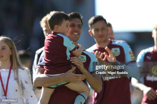 Jack Cork of Burnley enjoys the lap of honour with his child after the Premier League match between Burnley and AFC Bournemouth at Turf Moor on May...