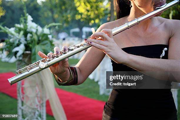 woman playing flute - classical music stock pictures, royalty-free photos & images