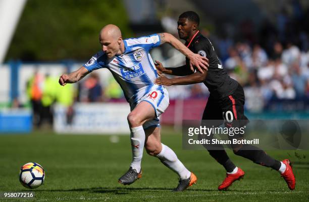 Aaron Mooy of Huddersfield Town and Ainsley Maitland-Niles of Arsenal battle for possession during the Premier League match between Huddersfield Town...