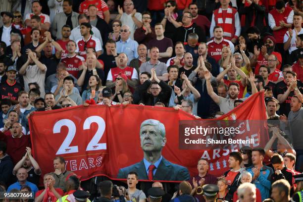 Fans hold up signs celebrating Arsene Wenger after the Premier League match between Huddersfield Town and Arsenal at John Smith's Stadium on May 13,...