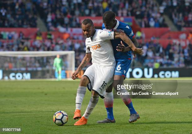 Swansea City's Jordan Ayew shields the ball from Stoke City's Kurt Zouma during the Premier League match between Swansea City and Stoke City at...