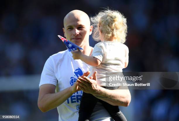 Aaron Mooy of Huddersfield Town enjoys the lap of honour with his child after the Premier League match between Huddersfield Town and Arsenal at John...