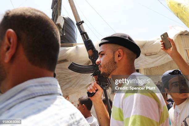 People march with the body of Jamal Affana as he brought through a Rafa, Gaza alleyway after he succumbed to a gunshot wound sustained during...