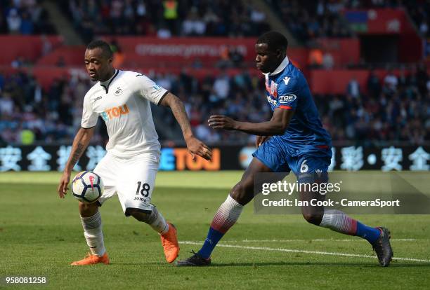 Swansea City's Jordan Ayew shields the ball from Stoke City's Kurt Zouma during the Premier League match between Swansea City and Stoke City at...