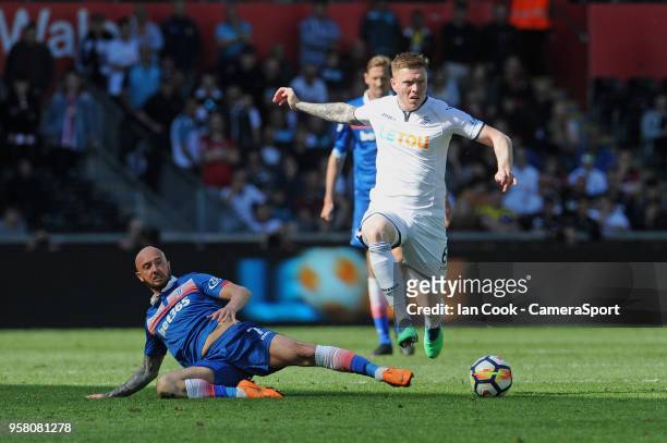 Swansea City's Alfie Mawson avaids the tackle from Stoke City's Stephen Ireland during the Premier League match between Swansea City and Stoke City...