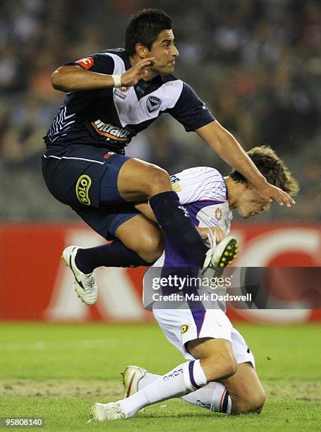 Carlos Hernandez of the Victory shoots at goal over Scott Neville of the Glory during the round 23 A-League match between the Melbourne Victory and...