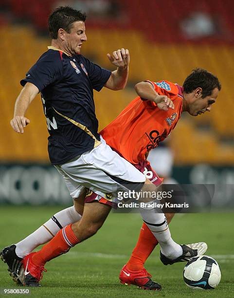 Massimo Murdocca of the Roar and Michael Bridges of the Jets compete for the ball during the round 23 A-League match between the Brisbane Roar and...
