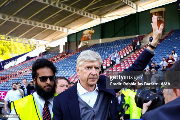 Arsene Wenger head coach / manager of Arsenal waves to the Arsenal fans at full time during the Premier League match between Huddersfield Town and...