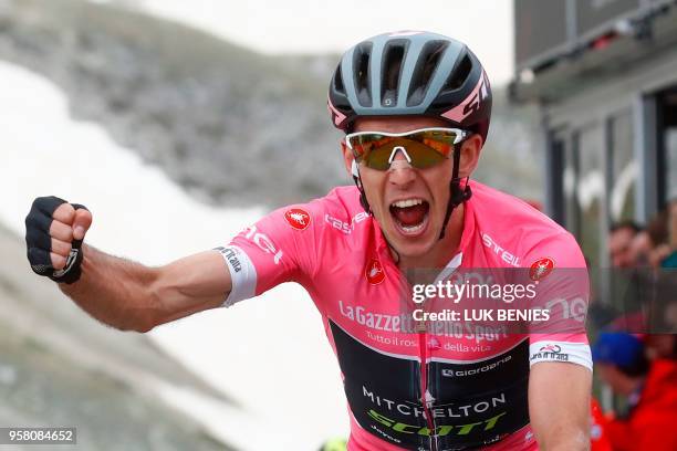 Pink jersey Britain's rider of team Mitchelton-Scott Simon Yates celebrates as he crosses the finish line to win the 9th stage between Pesco Sannita...