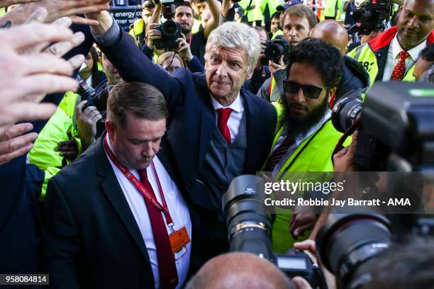 Arsene Wenger head coach / manager of Arsenal engages with the fans of Arsenal at full time after he comes back out during the Premier League match...